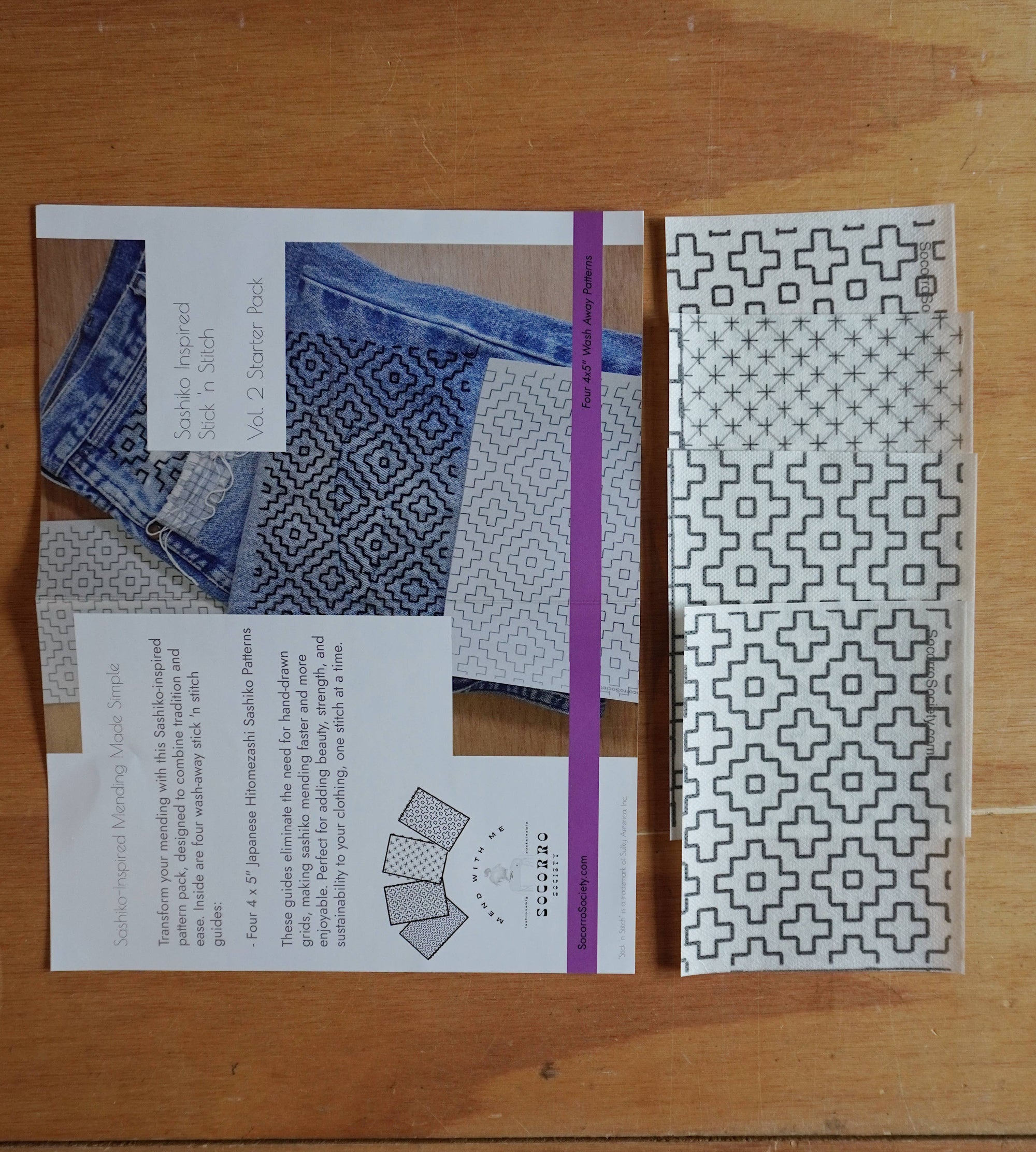 Patterned fabric swatch and design sheet on a wooden surface
