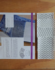 Patterned fabric swatch and design sheet on a wooden surface