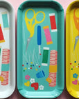 Four colorful trays with scissors and thread illustrations on a pink background