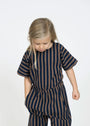 Child wearing a navy and beige striped outfit on a white background