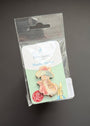 A Peter Rabbit Needle Pin set in its original clear plastic blister packaging, displayed against a dark gray background.