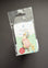 A Beatrix Potter 'Petty Rabbit' enamel pin in its original clear plastic packaging with a white backing card, displayed on a dark gray background.