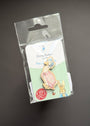 A Beatrix Potter 'Petty Rabbit' enamel pin in its original clear plastic packaging with a white backing card, displayed on a dark gray background.